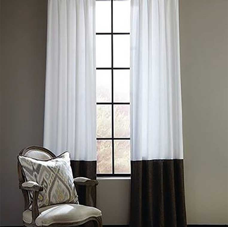 tall window with white and black curtains